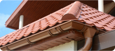 tiled roof against blue sky with clouds idea background with space text ecofriendly traditional roofs home 1 - Top Tejados Girona